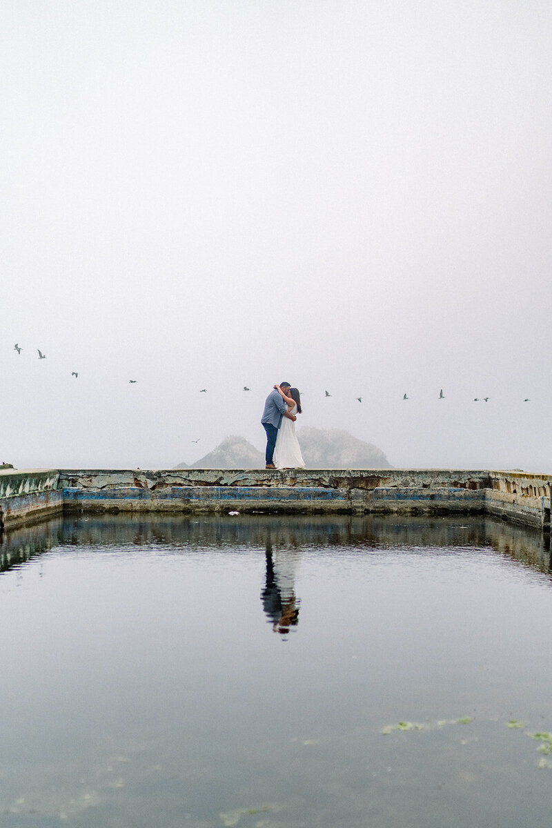 A serene engagement session at The Resort at Pelican Hill, showcasing the tranquil lakefront views, photographed by Tiffany Longeway Photography.