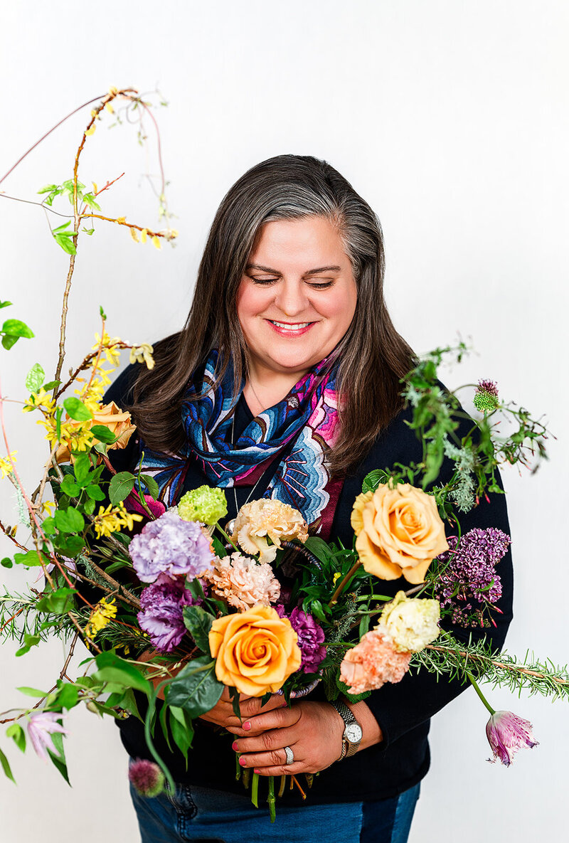 Happy client holding a beautiful flower arrangement