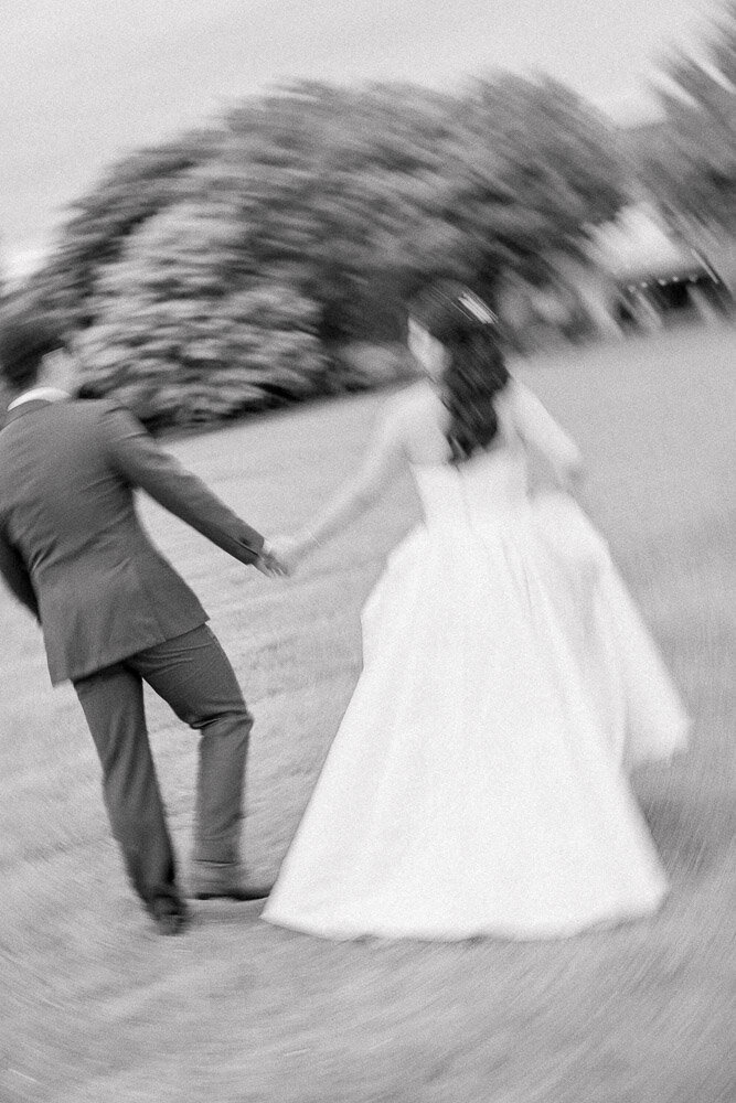 Wedding Photographer in Newport, RI, CT, and beyond | The Corteses | Back shot of bride and groom walking up the steps.