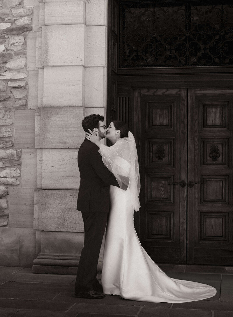 Groom and Bride kiss in front of The Graylyn Estate.