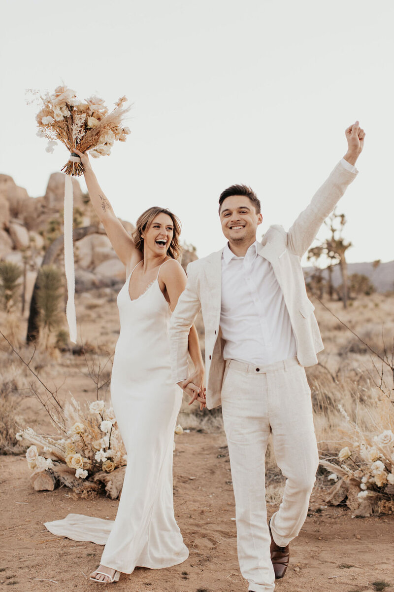 destination wedding photo of bride and groom in desert by Blooming Faith Photography