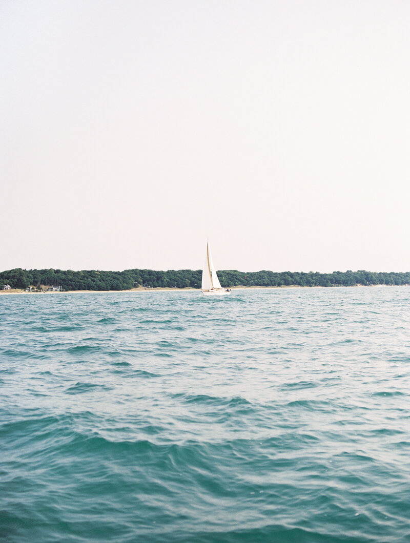 Sailboat gliding on Lake Michigan during a sailboat engagement session captured by Ohio wedding photographer