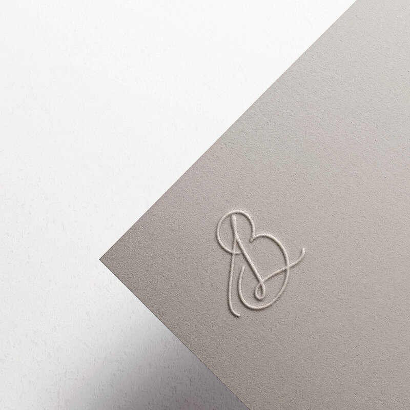 Elegant calligraphic monogram on taupe textured card for Belle Lumière Photography