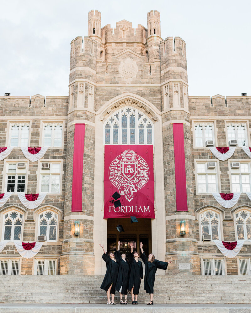 Graduates tossing caps in the air at Fordham University