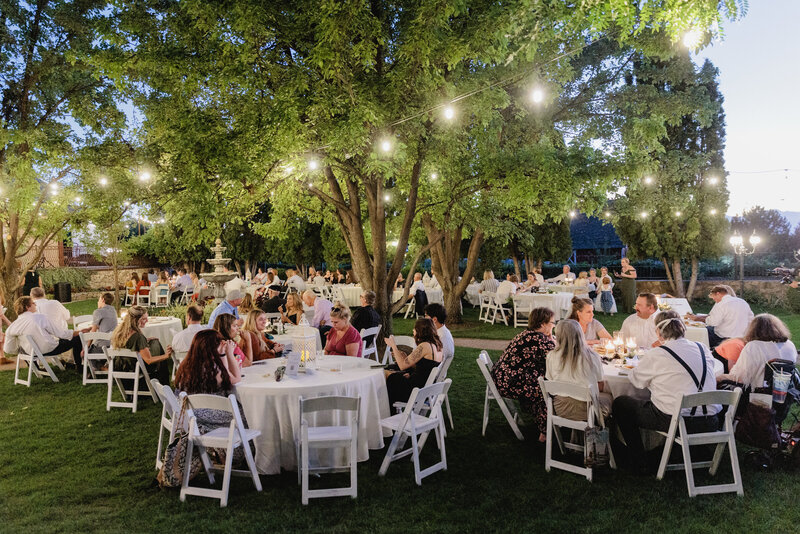 Twinkle lights draped above the fountain garden during a garden reception