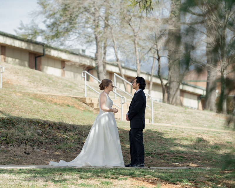 A catholic bride and groom spend an intimate moment with each other during their first look ahead of their wedding mass at St. Mary's catholic church in oak ridge, tennessee