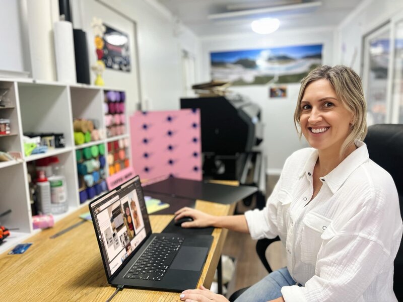 business owner sitting at computer desk in office