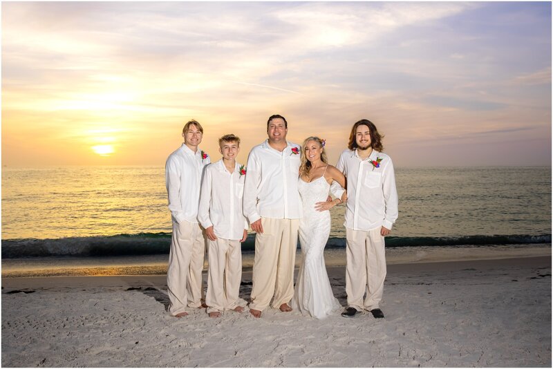 A family photo post vow renewal at sunset on Anna Maria Island beach at sunset