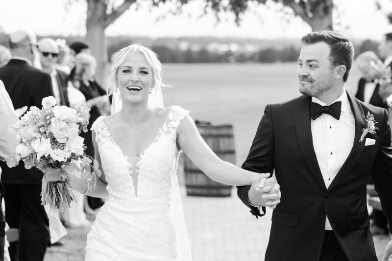 Nick and Lauren walking down the aisle after getting married at Younger Ranch in Colorado Springs.