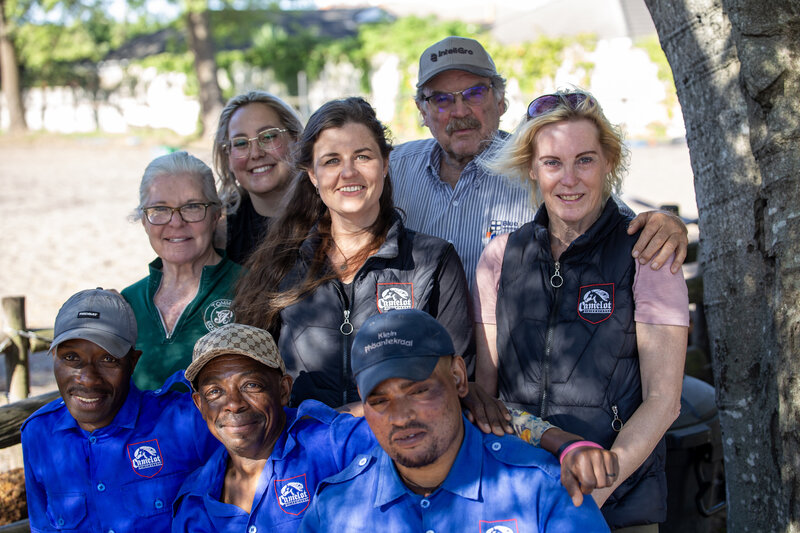 Camelot Horse Riding School team in Durbanville — instructors, grooms, and yard staff together at the stables.