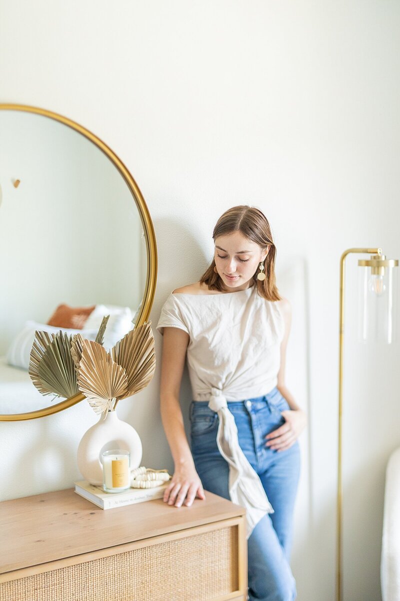 Natalie Barnas standing by bedroom dresser she styled.