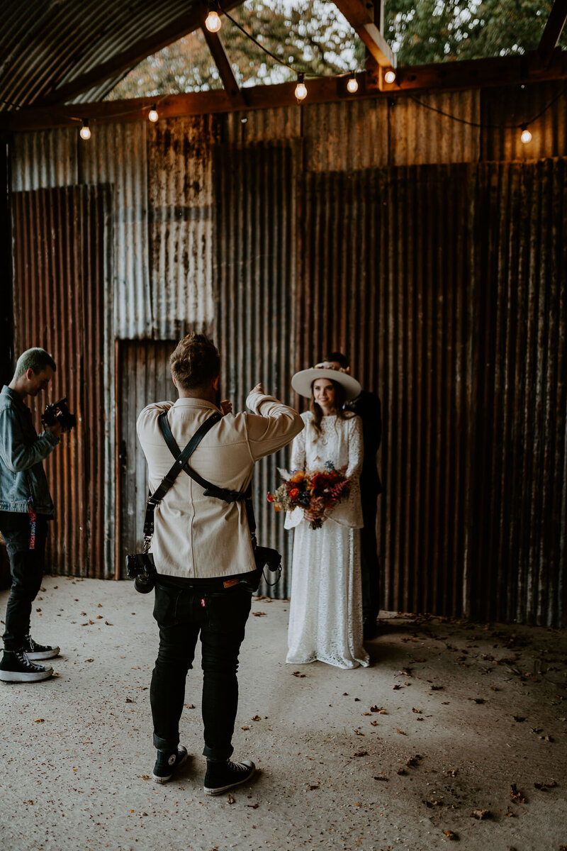 An untraditional wedding photographer posing a cool boho couple