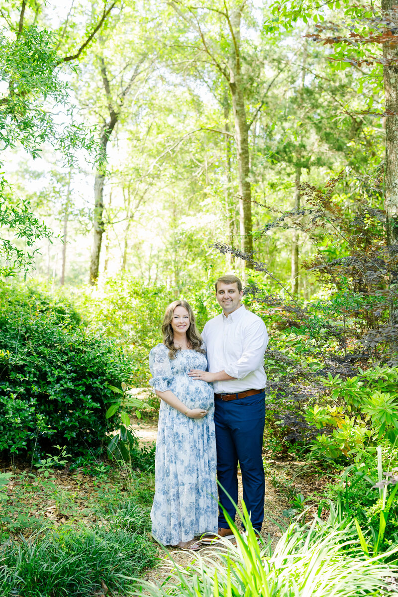 Man and woman standing in Dothan Alabama Woods for Maternity Photography Session