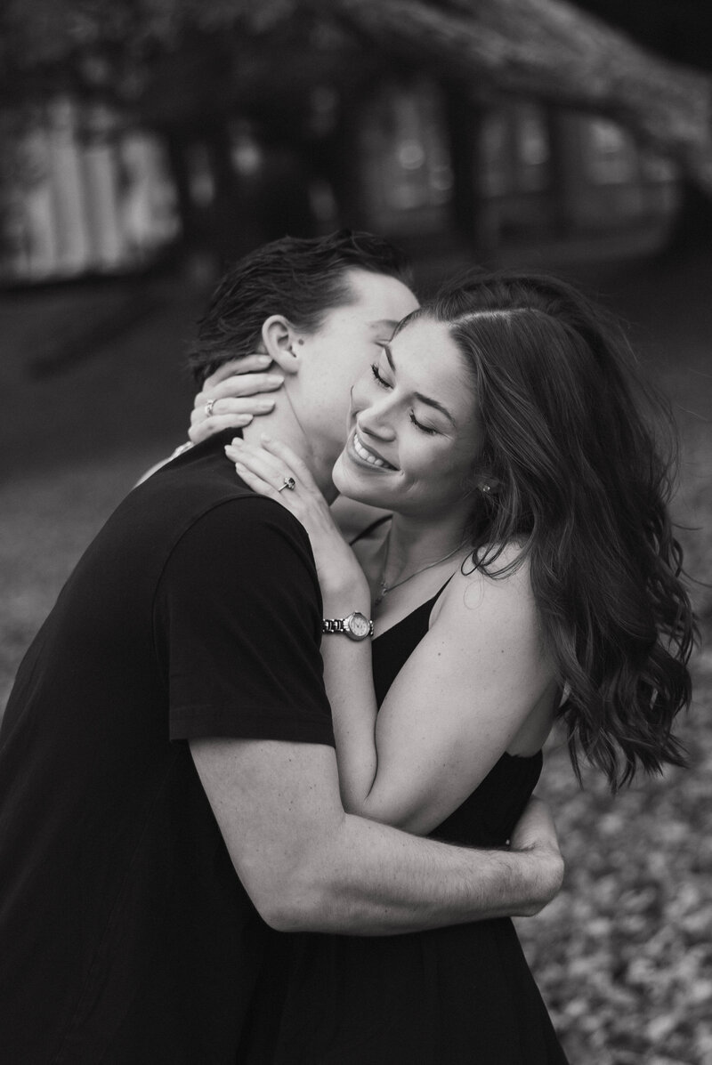 Man kissing woman's neck at Samford university