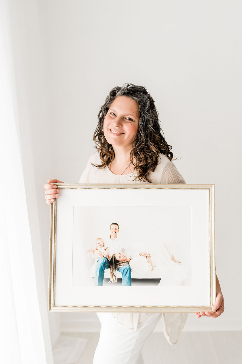 photographer holding a family picture in her hand