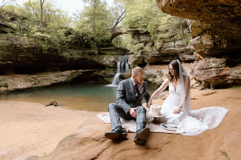 Bride and groom cutting cake at Old Man's Cave in Hocking Hills.