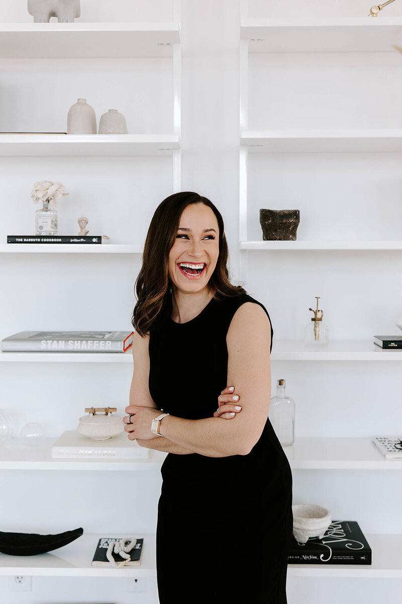 Samara is a New England Wedding Planner holding a laptop computer