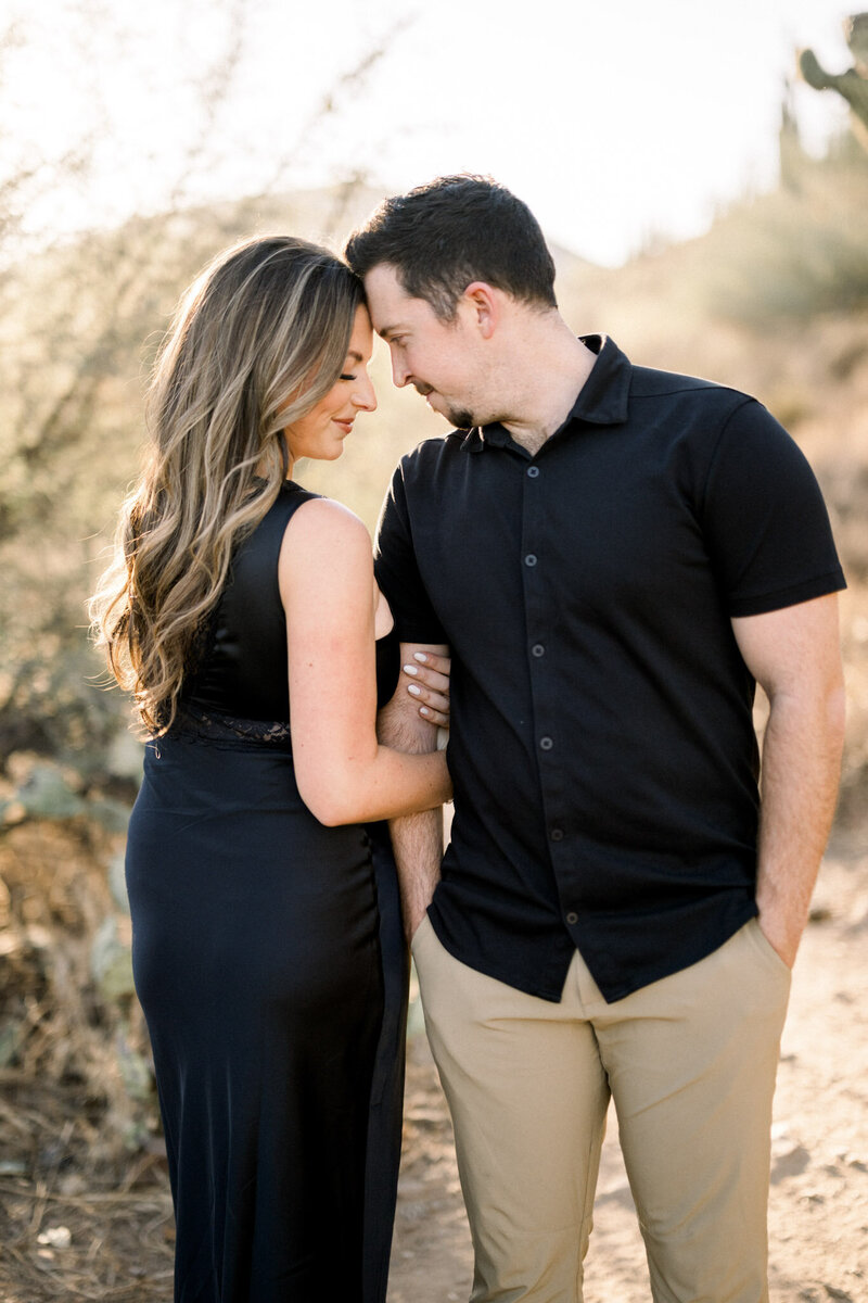 Megan & Sean - Scottsdale, Arizona - Intimate moment between couple in black attire with desert backdrop.