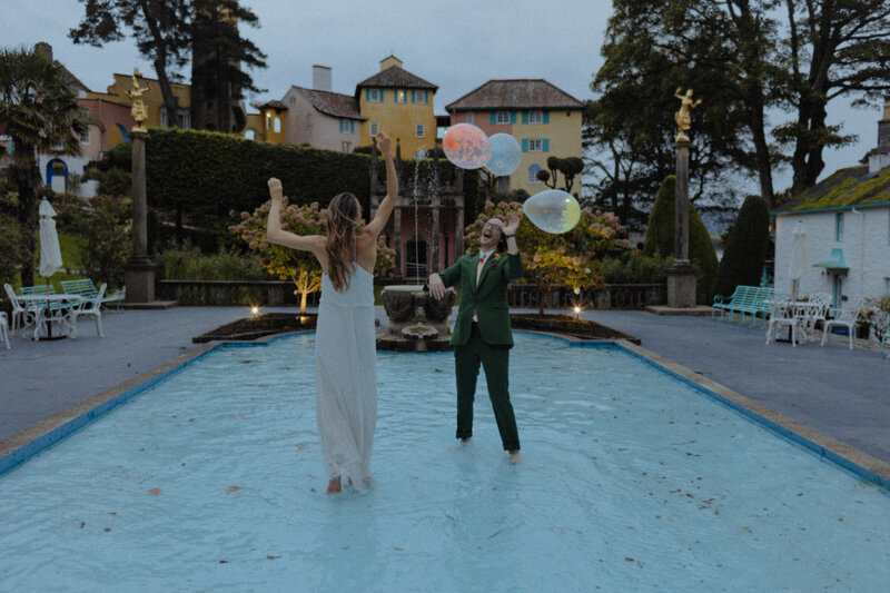 frances quinn and groom playing with balloons at portmeirion wedding