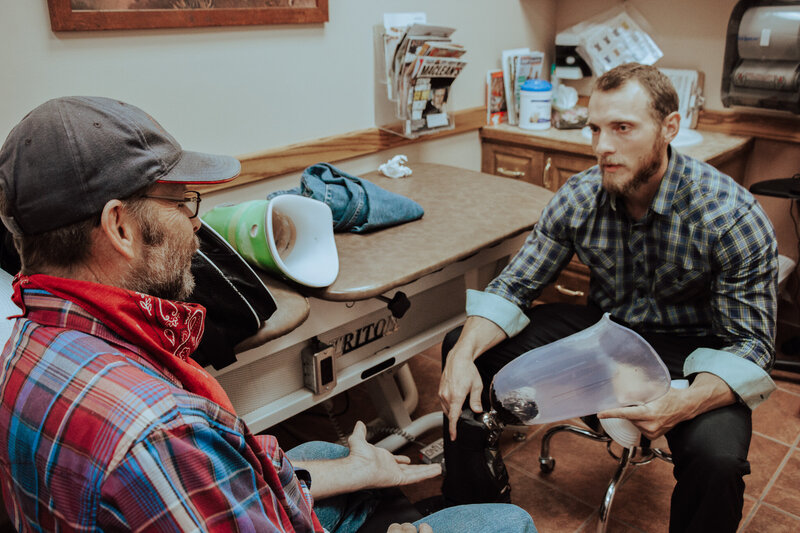 Lethbridge Orthotics' Lead prosthetic specialist Russ Beazer discussing prosthetics with a patient, providing expert guidance.