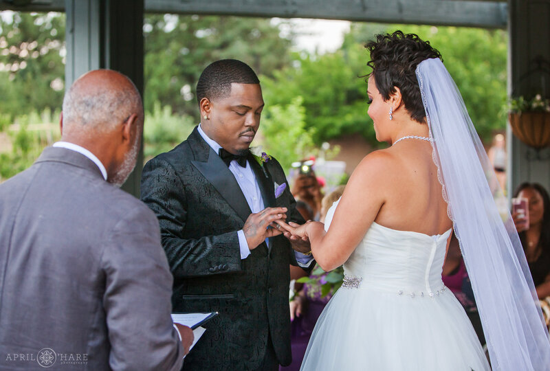 Couple exchange rings under the water garden gazebo at Denver Botanic Gardens
