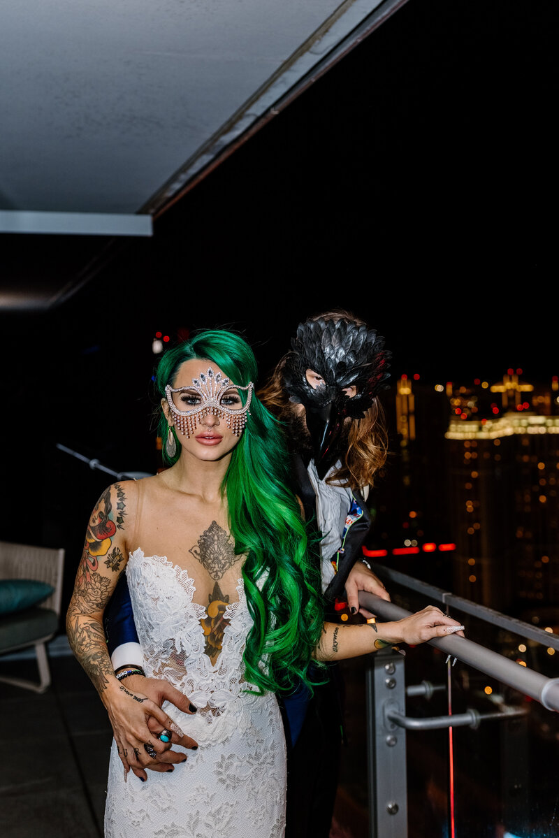 green haired girl in a wedding dress and groom with Halloween masks on