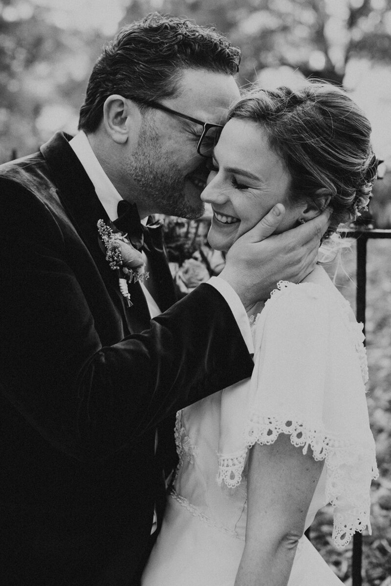 Black and White image of bride and groom embracing outdoors