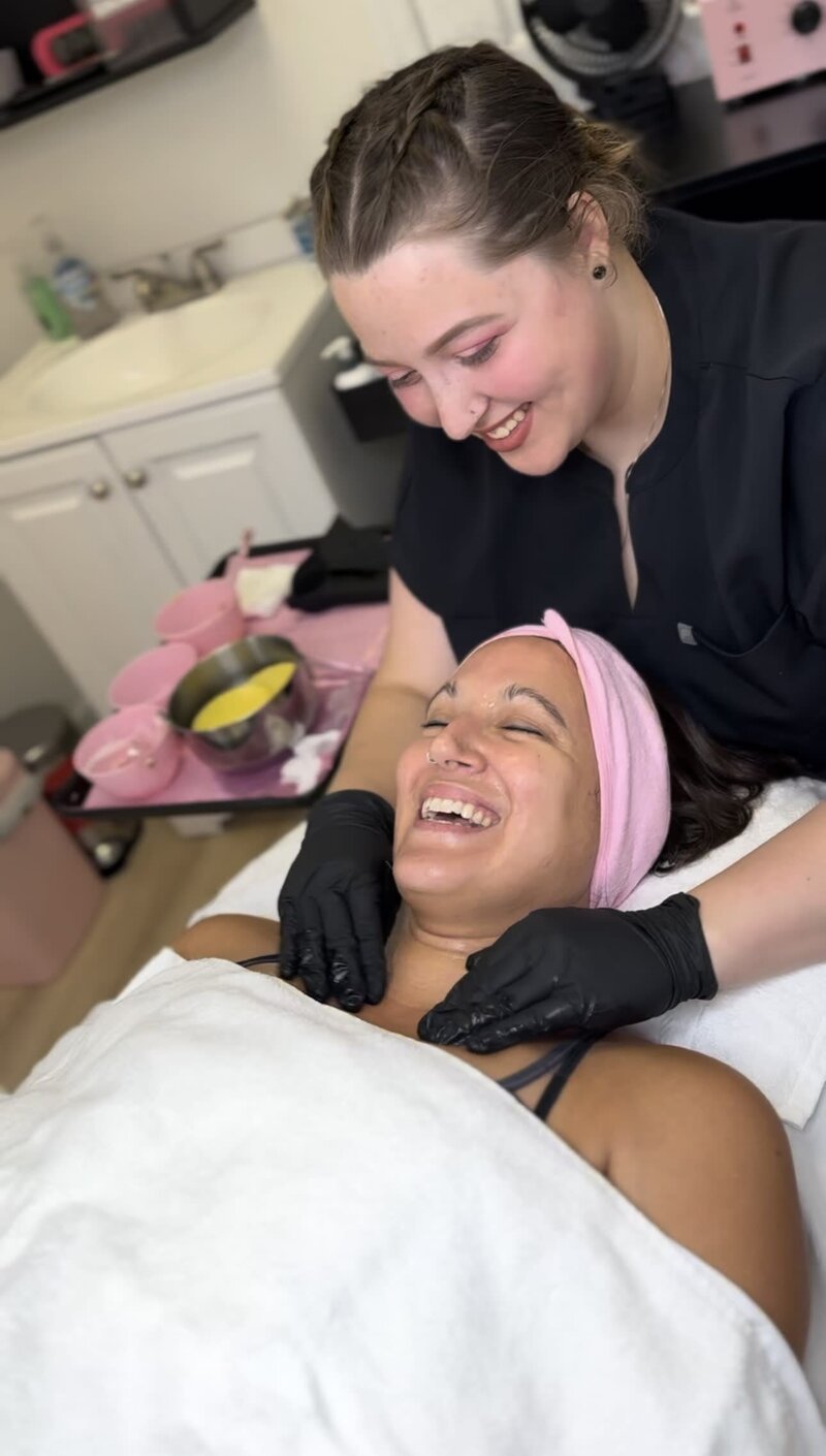 Esthetician giving client a facial