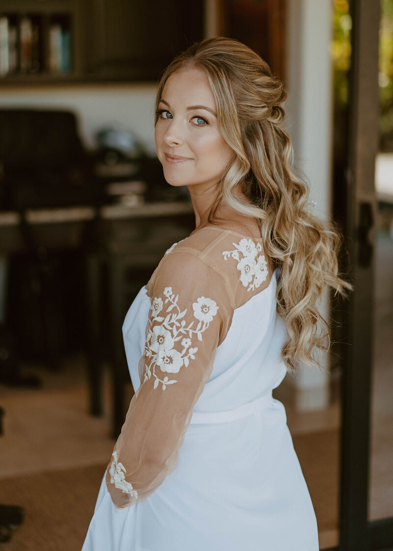 bride smiling and looking over her shoulder