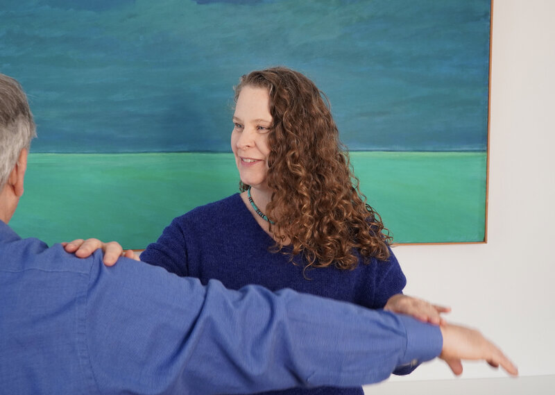 PSYCH-K session. Muscle testing a client's outstretched arm with gentle pressure to determine 'Yes' or 
