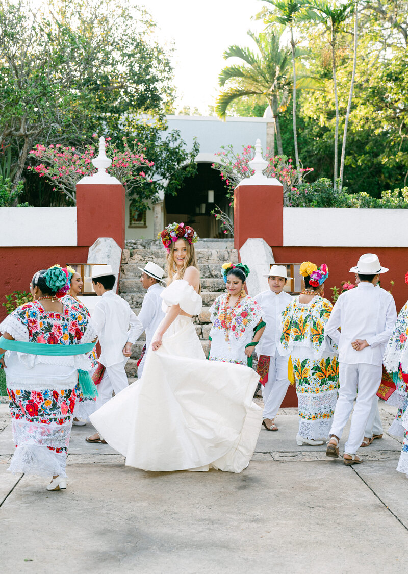Bride dances with local folklorico dancers at destination wedding in Mexico