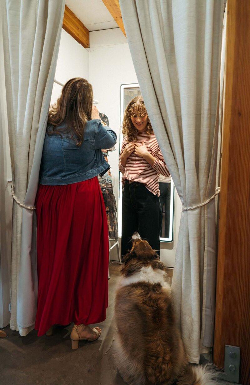 Accessories sitting on top of a shelf over a rack of jeans
