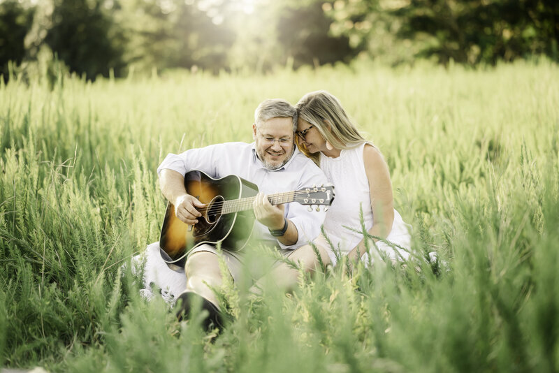 Beautiful field portrait of Kat Jones and her husband, Adam, in a natural field at sunset