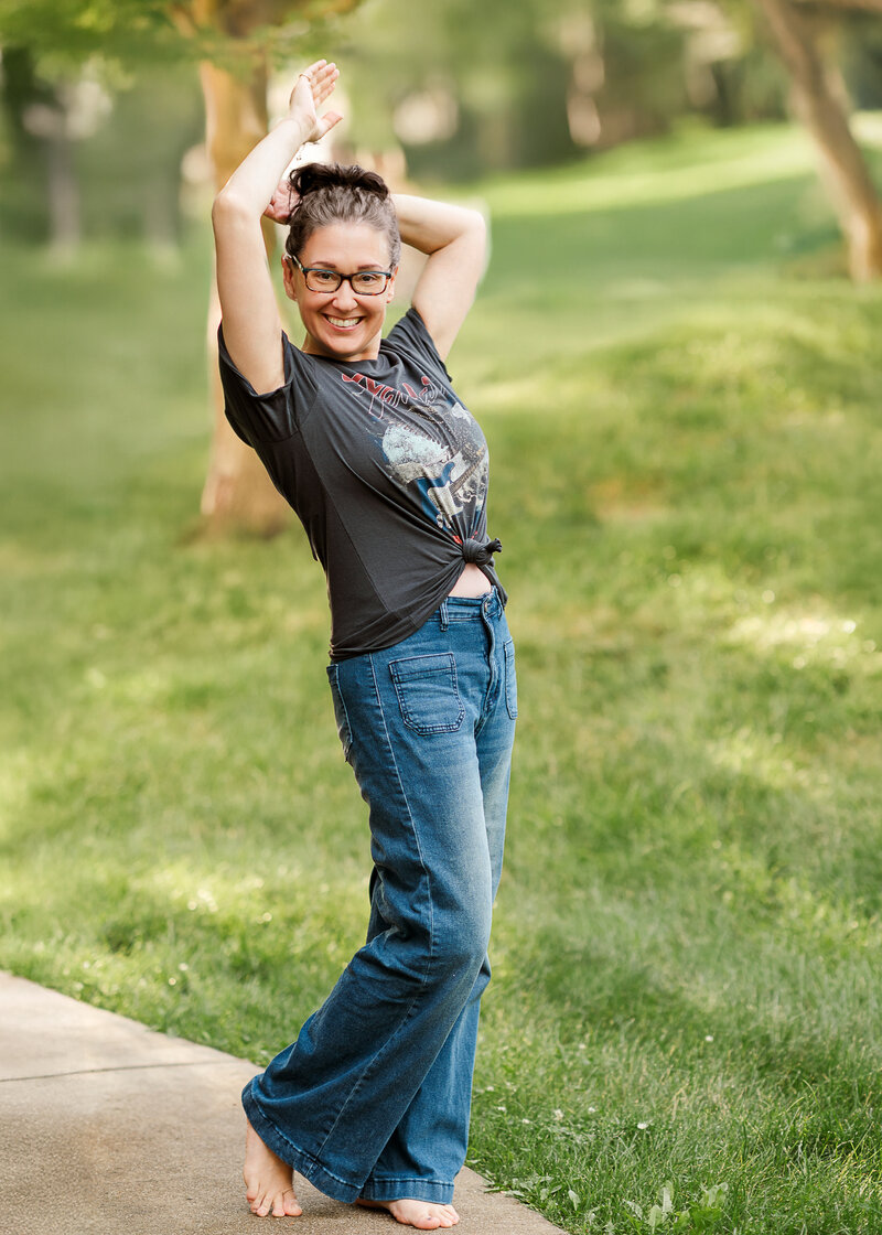 woman in wide leg jeans and vintage t shirt smiling by york pa photographer