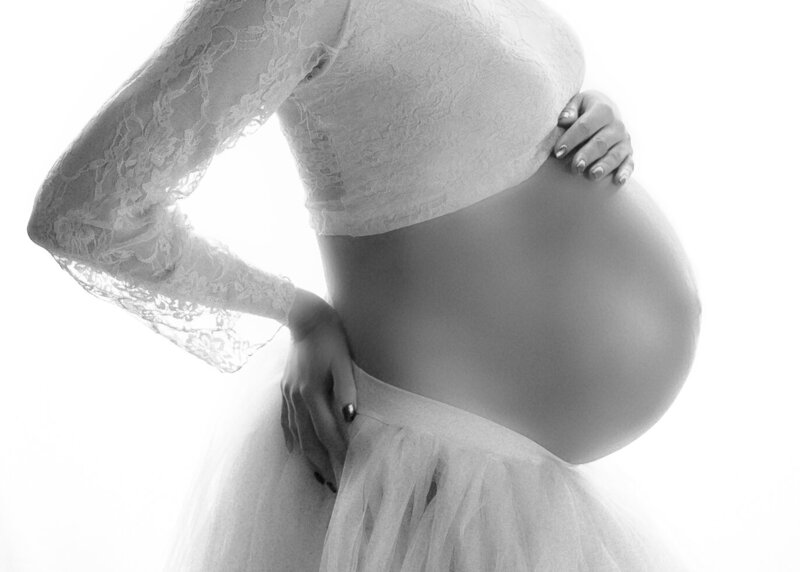 Black and white image of a pregnant belly
