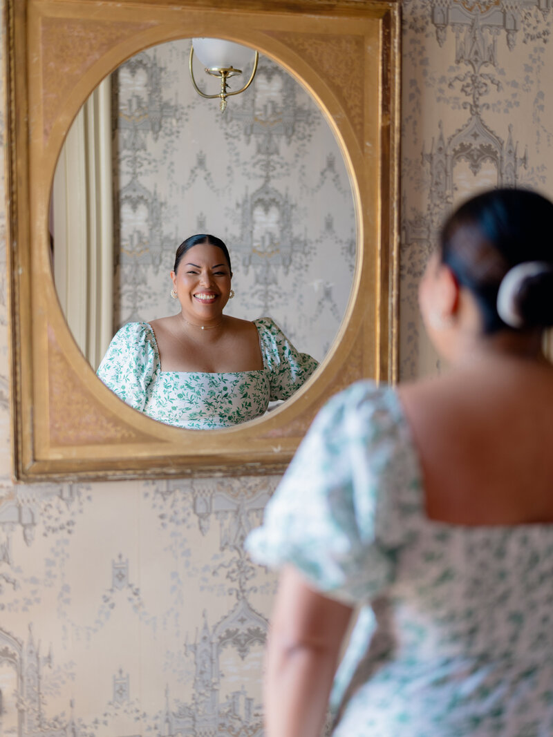 Jennifer Nolan headshot smiling into the mirror