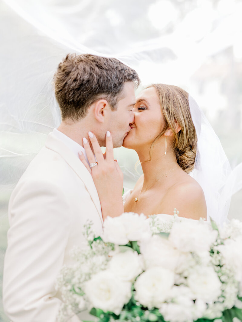 First kiss between bride and groom at luxury wedding | Something Borrowed Event Company
