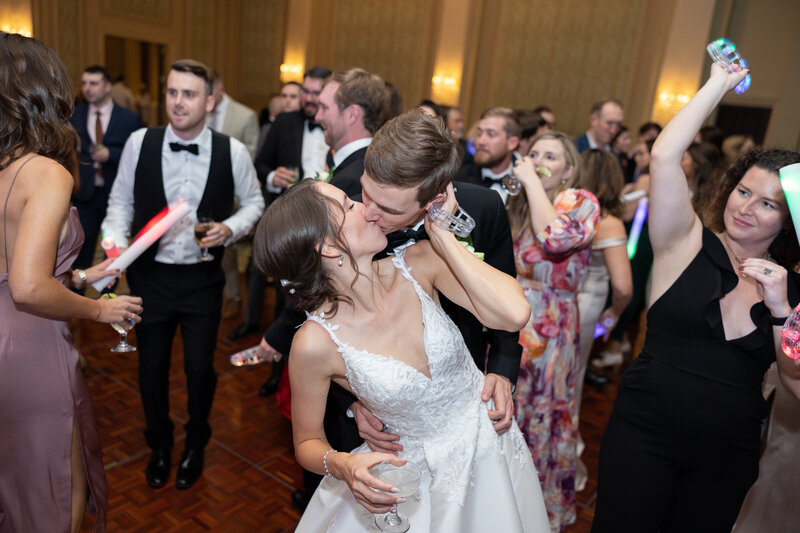 Bride kisses groom on dance floor at prestonwood country club