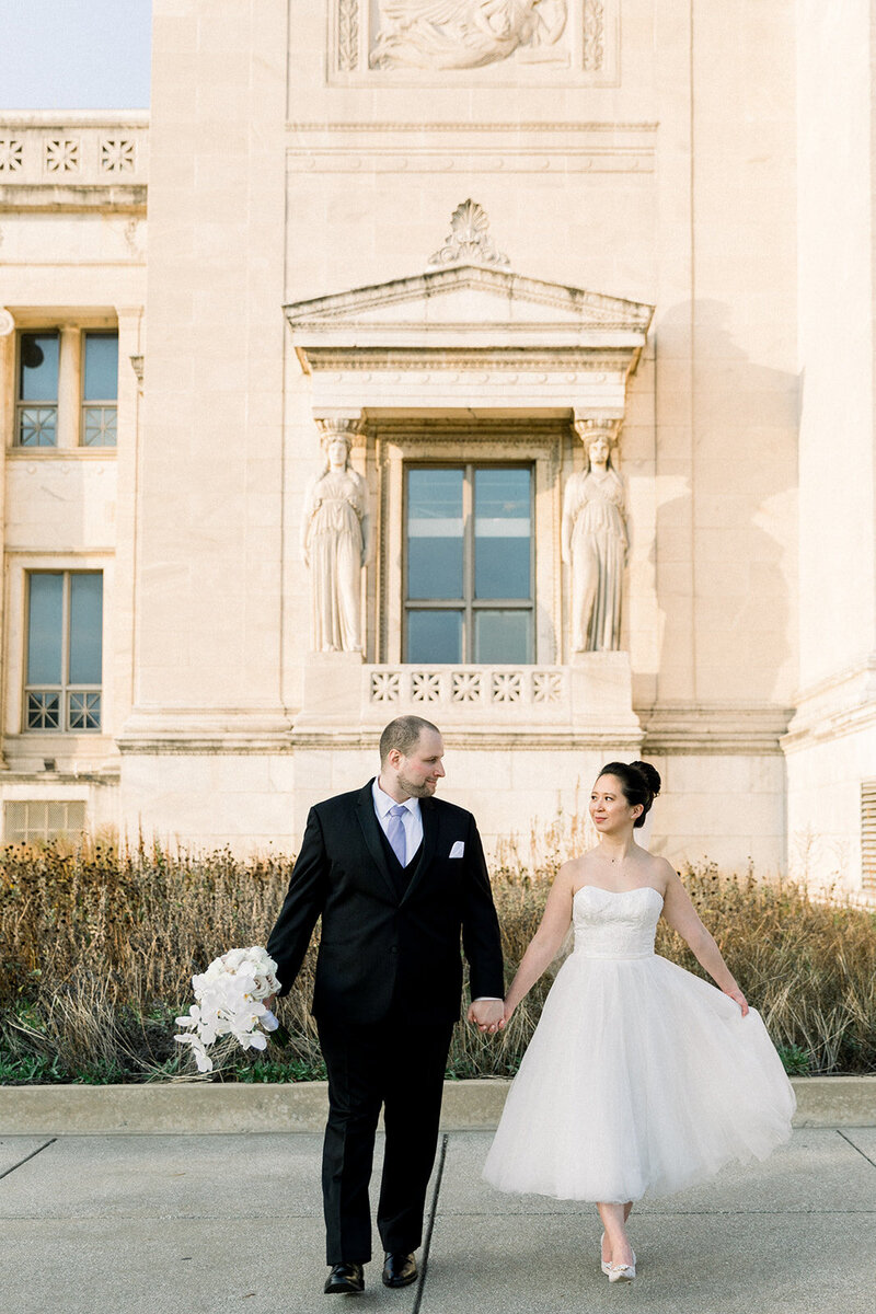 bride and groom walking in front of field museum