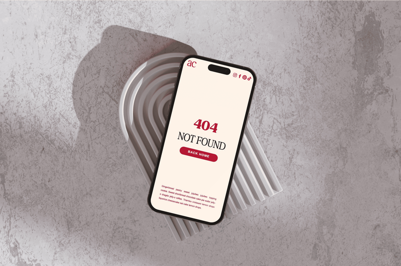 A smartphone displaying a 404 Not Found error message on its screen. The phone is resting on a textured surface with a curved, abstract shape behind it.