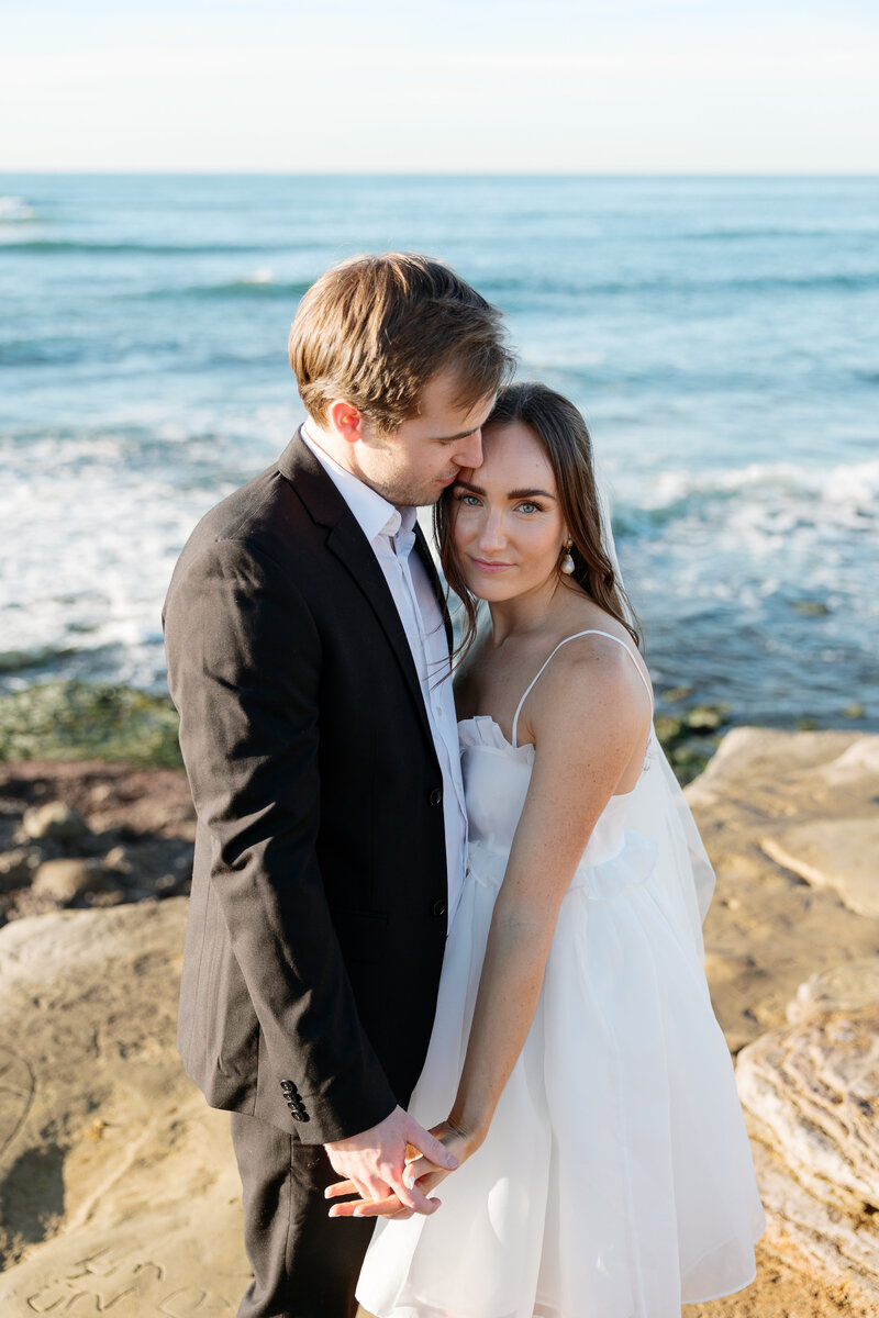Romantic sunset portrait of a couple at Sunset Cliffs on their La Jolla wedding day.