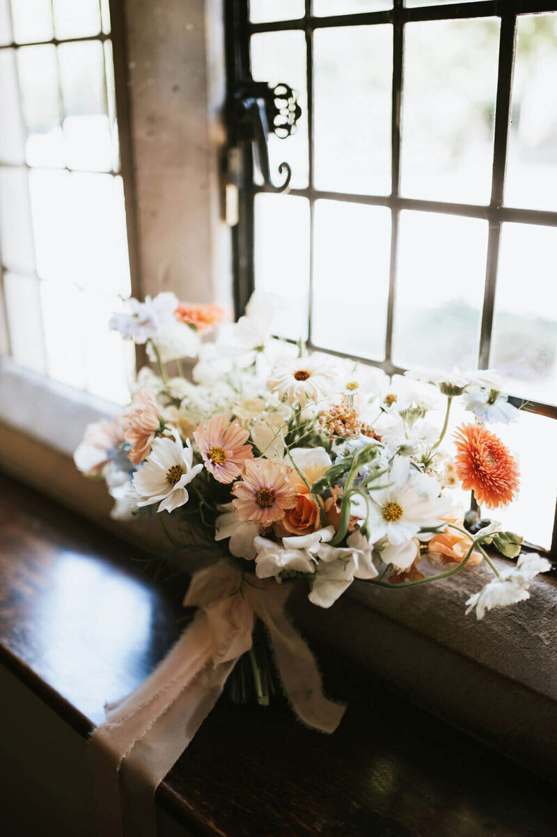 Wedding bouquet using apricot cosmos, asters and sweet peas at Broadfield Court