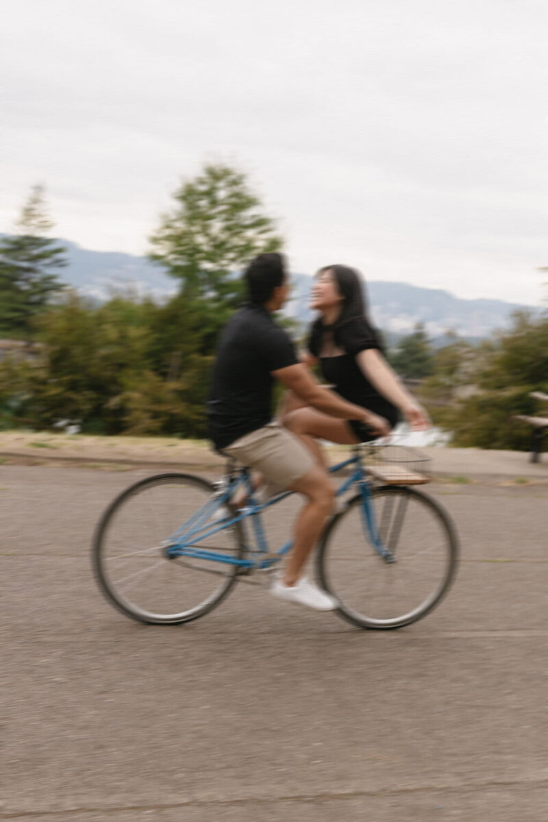 Riding a bike for engagement photos.