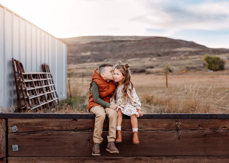 denver maternity photographer poses expecting mom with her husband in the fall at sunset
