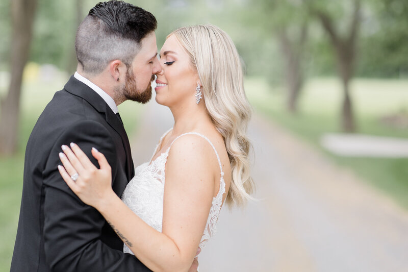 Bride and Groom going in for a kiss during portraits at Stonefield Estates wedding venue in Ottawa, Ontario. Photographed by Destination Wedding Photographer, Brittany Navin Photography