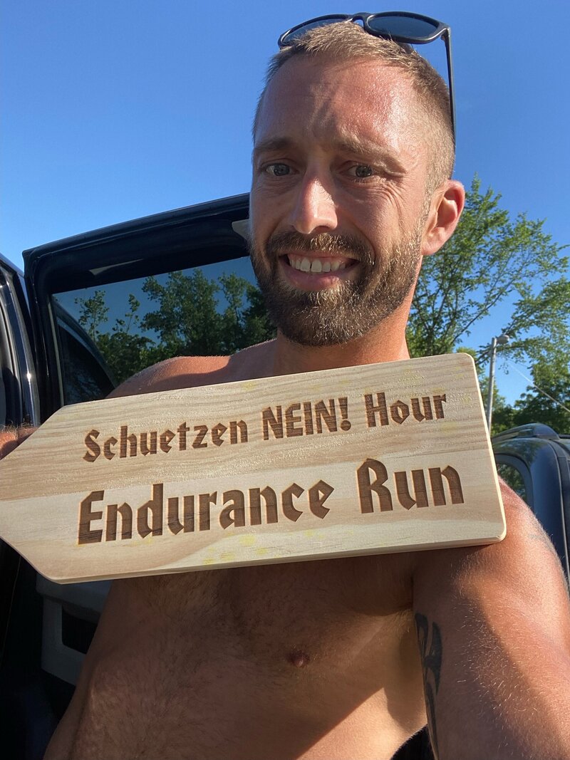 Dan holding a sign that says endurance run