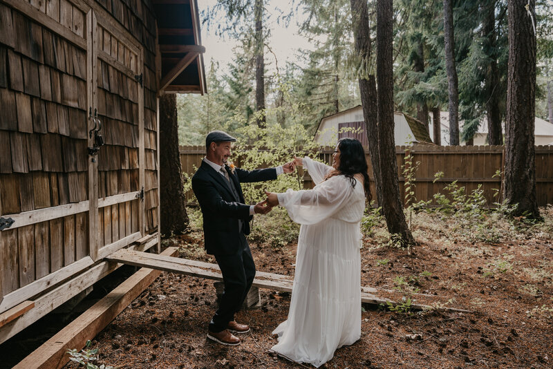 Candid image of couple dancing during their first look.