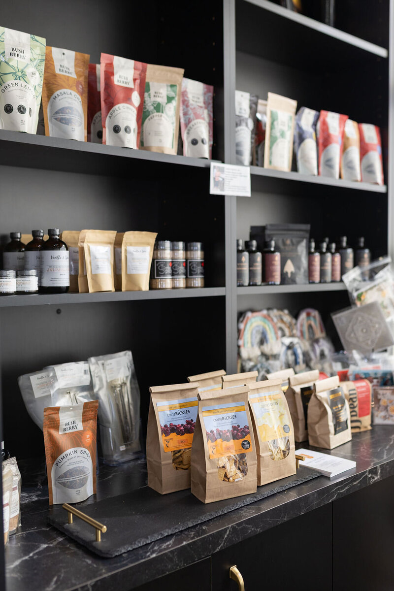 Shelf display of gourmet baking supplies, spices, and packaged treats available at Gold Leaf Pastries in Kamloops BC.