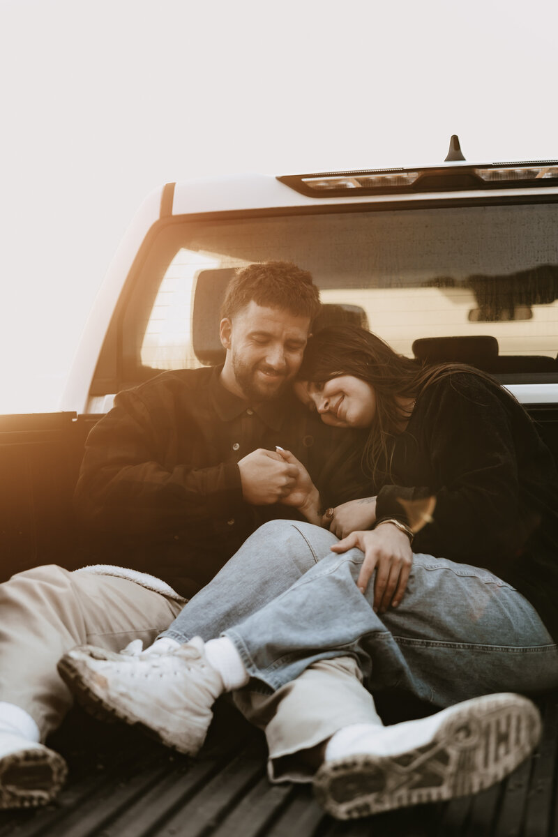 Adventurous couple in a pickup truck at Cape Kiwanda