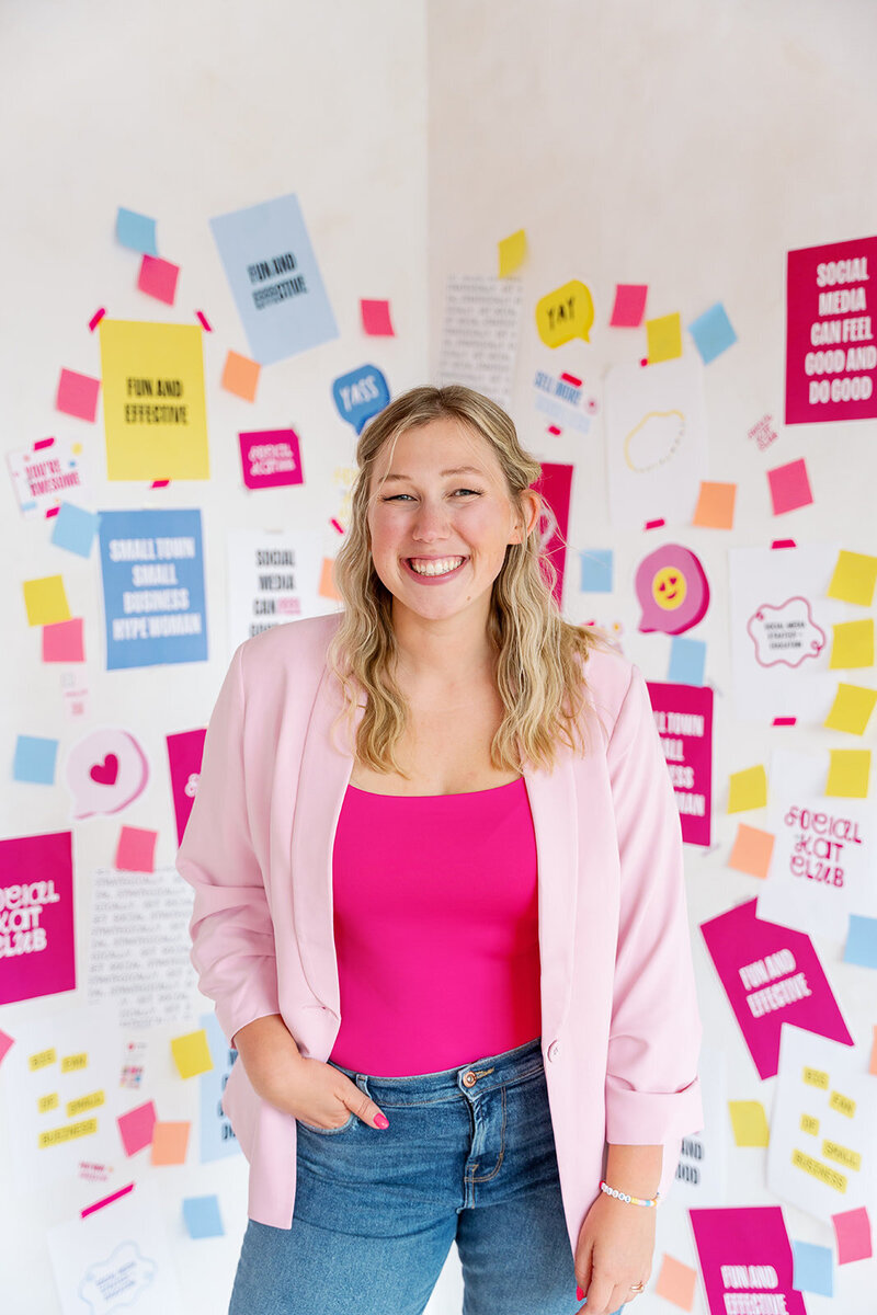 Kat Murphy in a blue blazer holding up a yellow Pantone on Fashion book